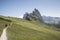 Three tourists walk on the path of the Italian Alps