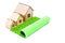 Three toy houses and fake grass roll on white