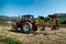 Three tractors plowing a field