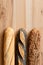 Three traditional baguettes on light wood. Plain, whole wheat and poppy seed. Top view. Space for text