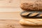 Three traditional baguettes on light wood. Plain, whole wheat and poppy seed. Top view. Space for text