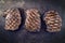 Three traditional barbecue entrecote beef steaks on a rustic old board