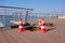 Three traffic cones standing on boundary of open hatch