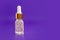 Three transparent bottle with cosmetic serum closeup on a purple background. Place for text