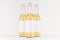 Three transparent longneck beer bottles 500ml with blank white label on white wooden board, mock up.
