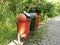 three trash cans by the roadside