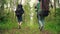 Three travelers with backpacks go in forest. Group of young friends travel