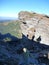 Three trekkers shadow silhouettes at the rock in mountains