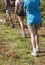 Three trekkers wearing boots walking on a trail