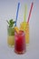 Three tropical mixed drinks with lime and lemon and mint leaves served in different glasses isolated on white.