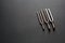 Three tuning forks on a black background