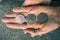 Three Tunisian coins on the woman\'s palm