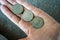 Three Tunisian coins on the woman\'s palm