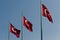 Three Turkish flags waving.