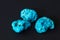 Three turquoise minerals on black background