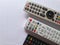 Three tv remotes on white background