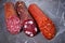 Three types of appetizing uncooked smoked sausage