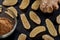 Three types of ginger. Ginger root, ground ginger and dry fruit ginger on a stone black plate on a brown tree table. Against