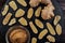 Three types of ginger. Sharp root ginger, ground ginger and dried fruit ginger on a stone black plate on a brown tree table.