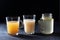 Three types of Homemade Beef Bone Broth in Glasses on a black background