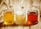 Three types of sweet honey: May linden, white clover, dark buckwheat in small jars, selective focus