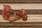 Three ugly funny potato on a striped wooden background with copy space. Concept - Unusual vegetables and fruits. Reduce amount of