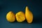 Three ugly lemons in a row on a dark blue textured background. Closeup. The concept is food waste reduction. Eating ugly or