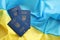 Three Ukrainian biometrical passports on folded waving flag of Ukraine country