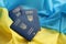 Three Ukrainian biometrical passports on folded waving flag of Ukraine country