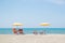 Three Umbrellas and Chairs at sandy beach in Durres, Adriatic Sea shore of Albania