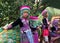 Three unidentified Akha children pose for tourist photos at Wat Phratat Doi Suthep on in Chiang Mai, Thailand.