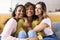 Three united beautiful smiling women sitting together on couch