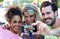 Three university students taking a selfie in the street.