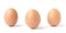 Three upright brown chicken eggs.