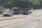 Three UPS vehicles travel down Atlanta street