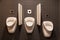 Three urinals in a bathroom
