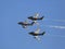 Three US Air force F-86 Sabre jet fighters in a close formation against blue sky