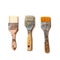 Three used flat brushes in a row for paint, lacquer, varnish or stain isolated with shadows on a white background, copy space, top