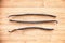 Three vanilla pods aligned on wood