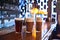 Three varieties of freshly brewed natural beer on a dark pub