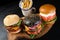 Three variety Beef burger served in black charcoal bun fries