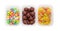 Three variety of the candies in small plastic containers closeup