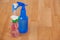 Three various spray bottles on wooden floor