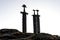 Three viking swords planted into ground on top of a rock at the sea shores of Hafrsfjord, Stavanger