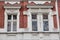 Three vintage designer window on the facade of the old brick house