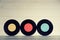 Three Vinyl records yellow red and blue