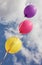 Three vivid color balloons on blue sky background