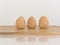 Three walnuts on a wooden board