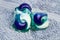 Three washing machine detergent pods on a blue towel