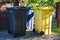 Three waste bins for mixed waste are in the yard